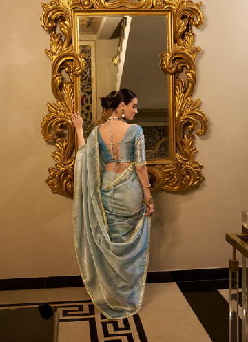 Party wear Sky Blue Tissue shimmer saree with zari weaving and sequin lace.